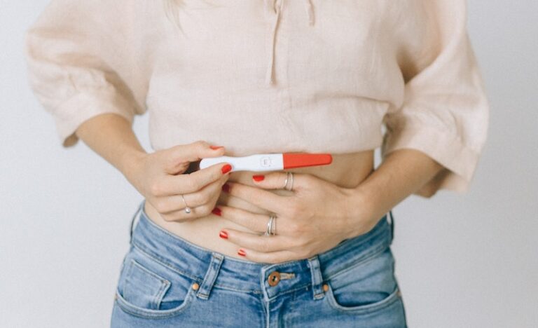 Woman Holding a Positive Pregnancy Test