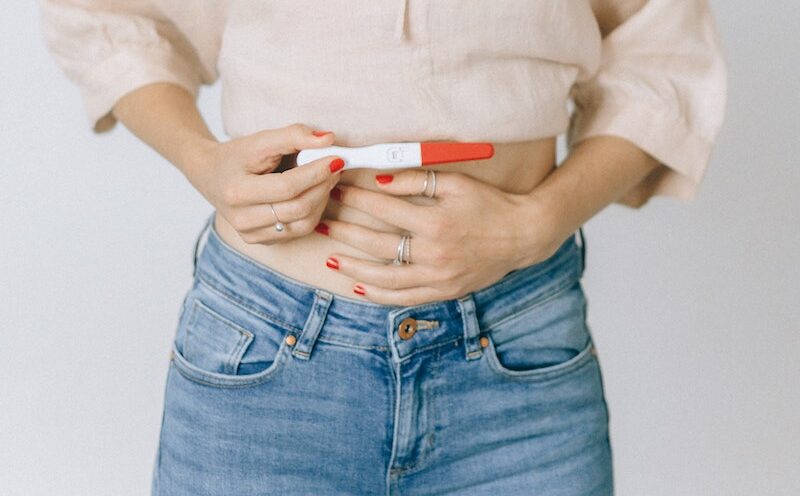 Woman Holding a Positive Pregnancy Test