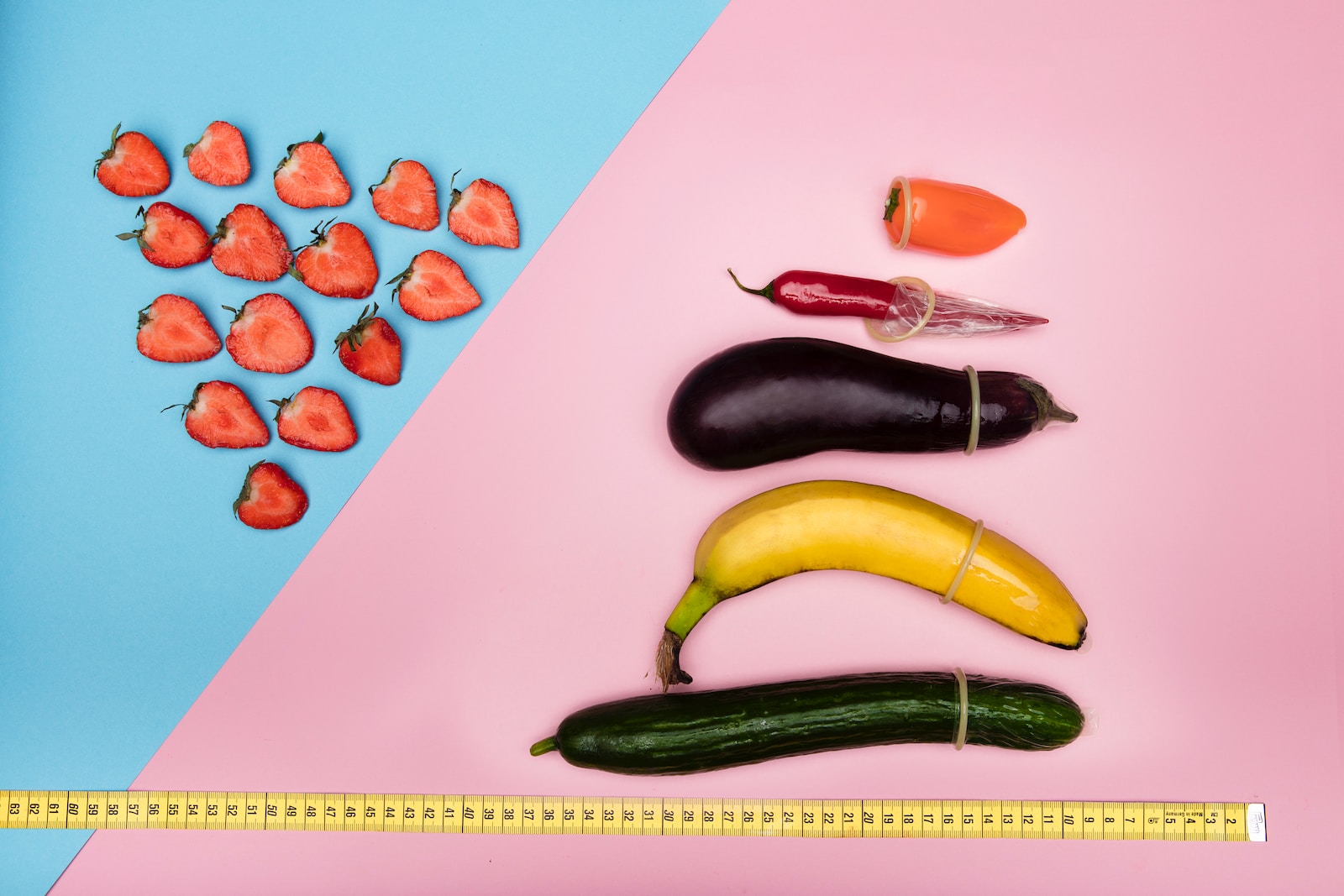 green cucumber and orange fruits on pink table