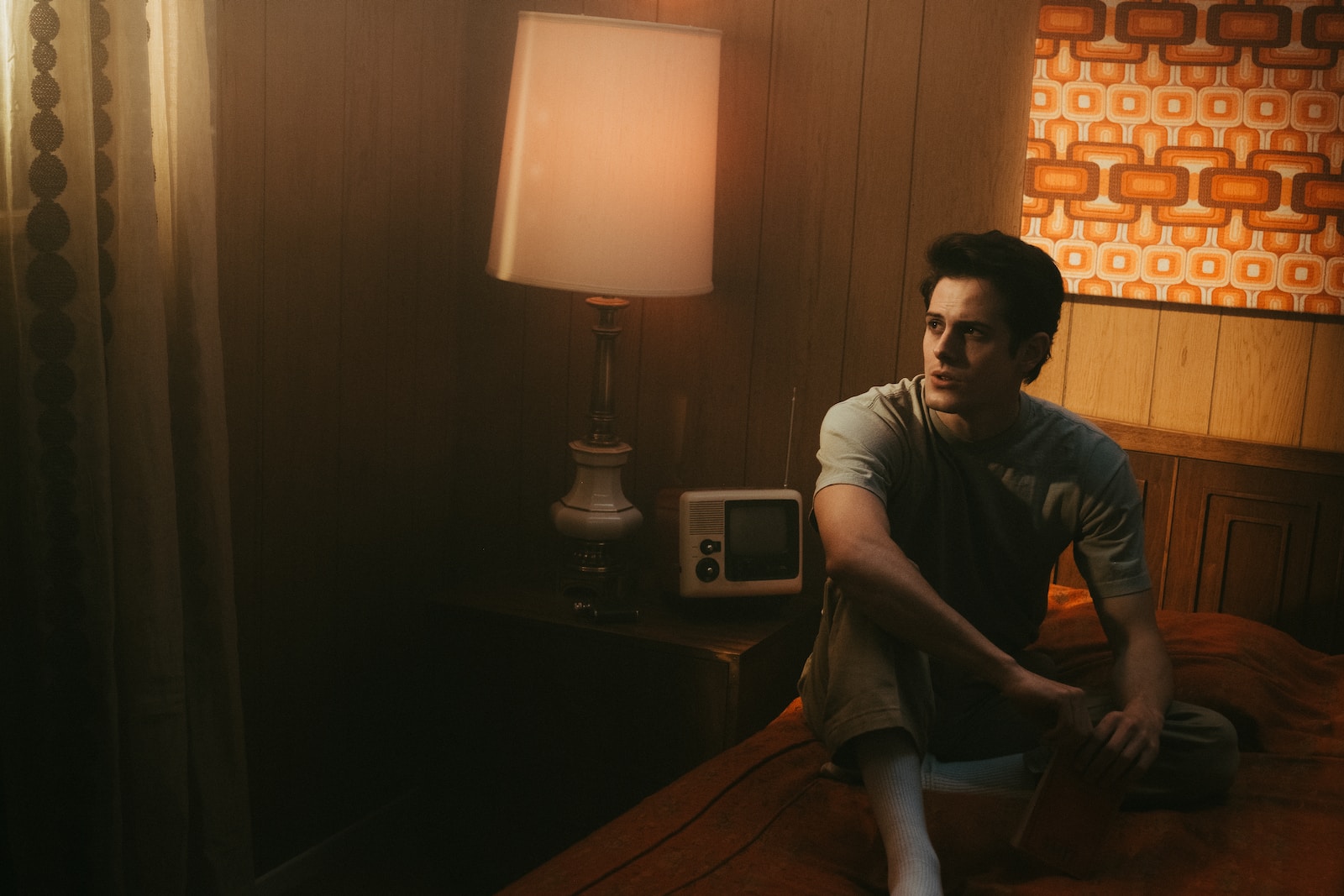 man in black crew neck t-shirt sitting on chair