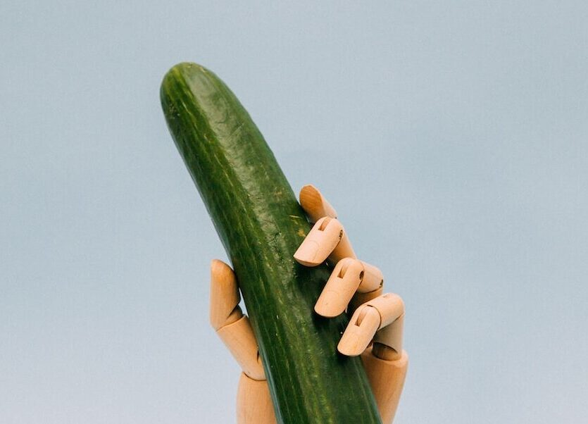 person holding green gourd with artificial hand rack