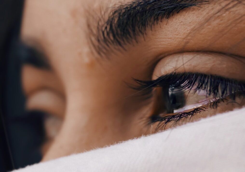 shallow focus of a woman's sad eyes