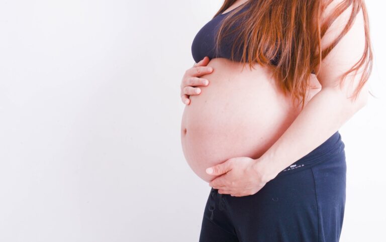pregnant holding her tummy